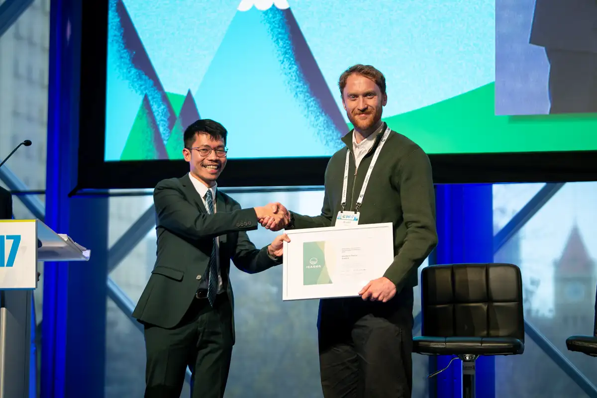 Elliot Ross receives the Student Poster Award on stage at GHGT-17 in Calgary